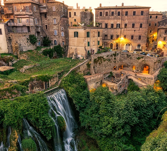 Tivoli's historic buildings and cascading waterfall near Rome.