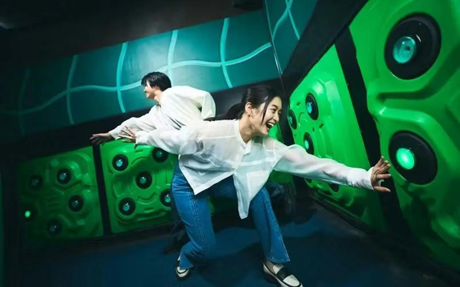 Tourists interacting with a game at Tokyo Dome City.