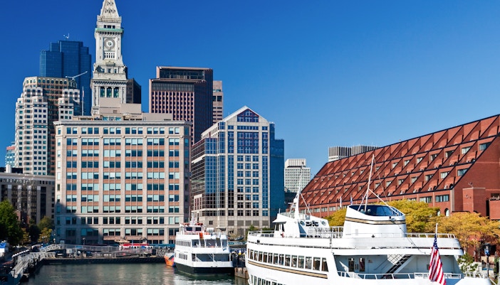 Cruise ships docked at Long Wharf with Boston skyline in the background.