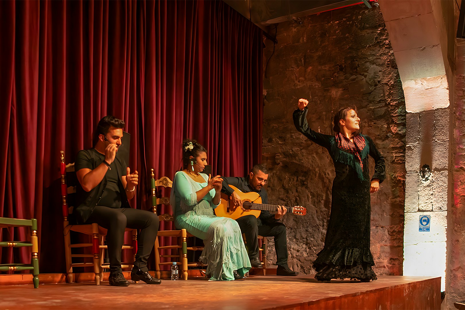 Flamenco performers on stage at Palau Dalmases, Barcelona.