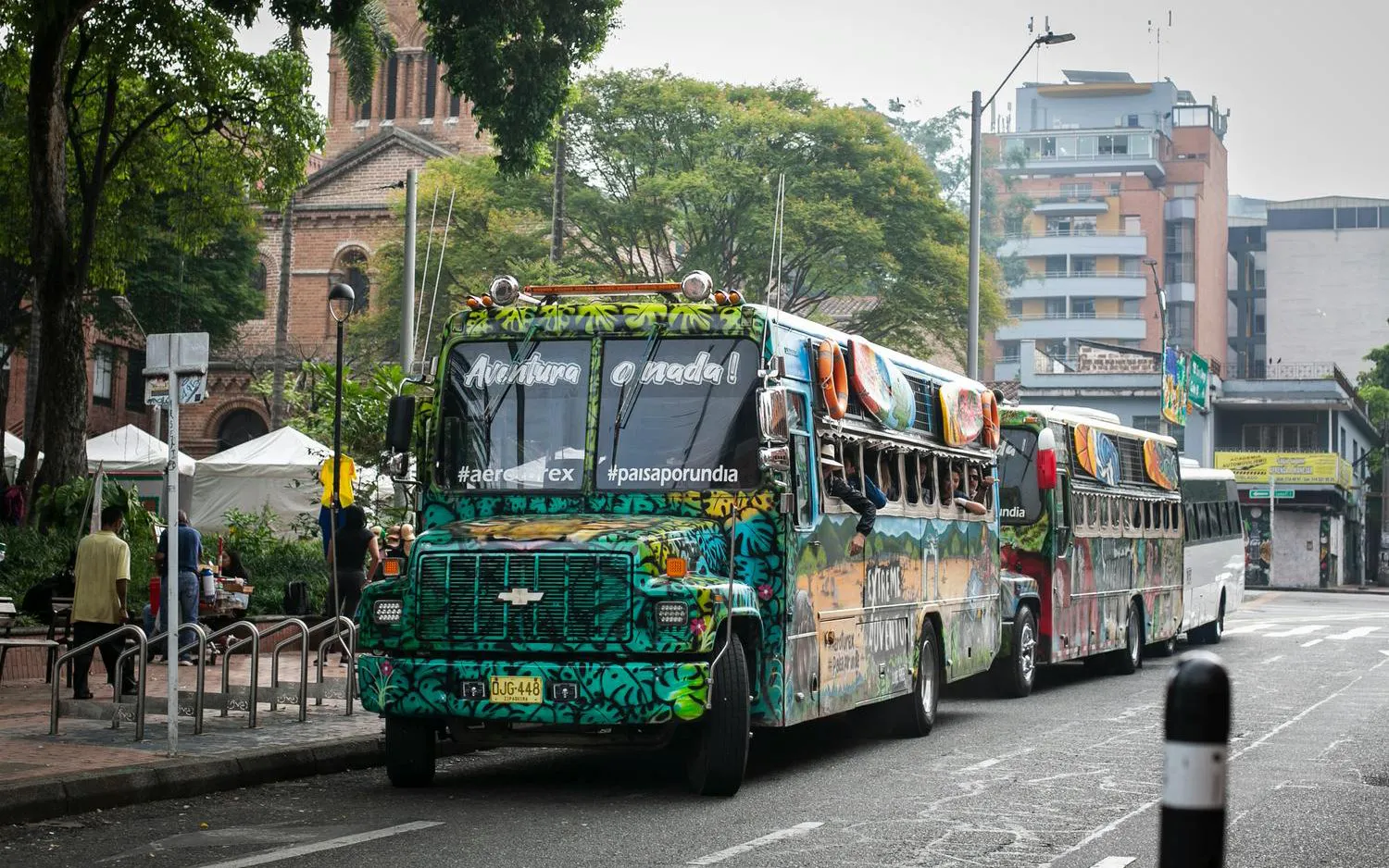 Traditional colorful chiva bus parked on a street in Colombia for Guatapé Adventure tours.
