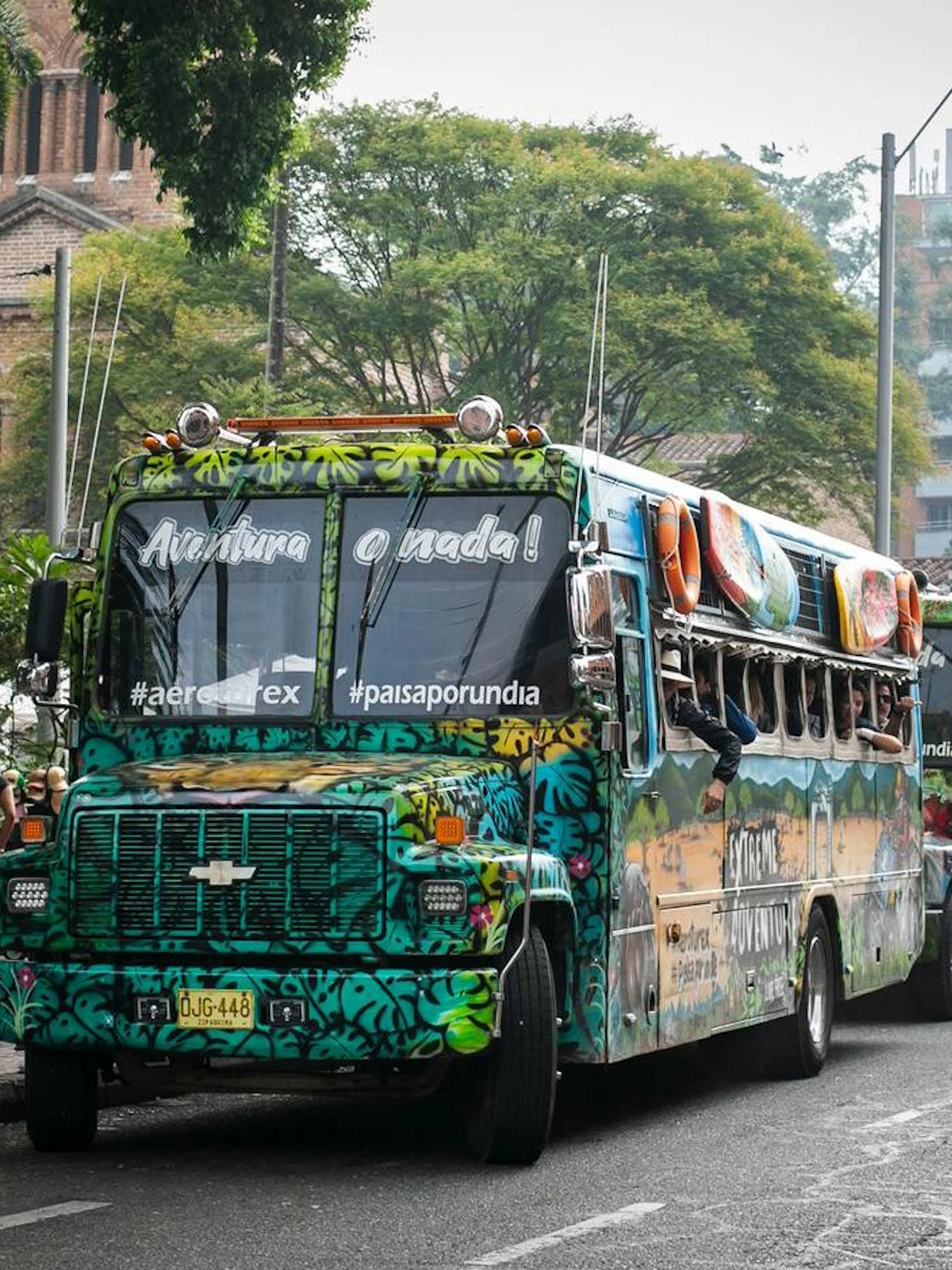 Traditional colorful chiva bus parked on a street in Colombia for Guatapé Adventure tours.