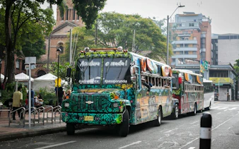 Traditional colorful chiva bus parked on a street in Colombia for Guatapé Adventure tours.