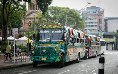 Traditional colorful chiva bus parked on a street in Colombia for Guatapé Adventure tours.