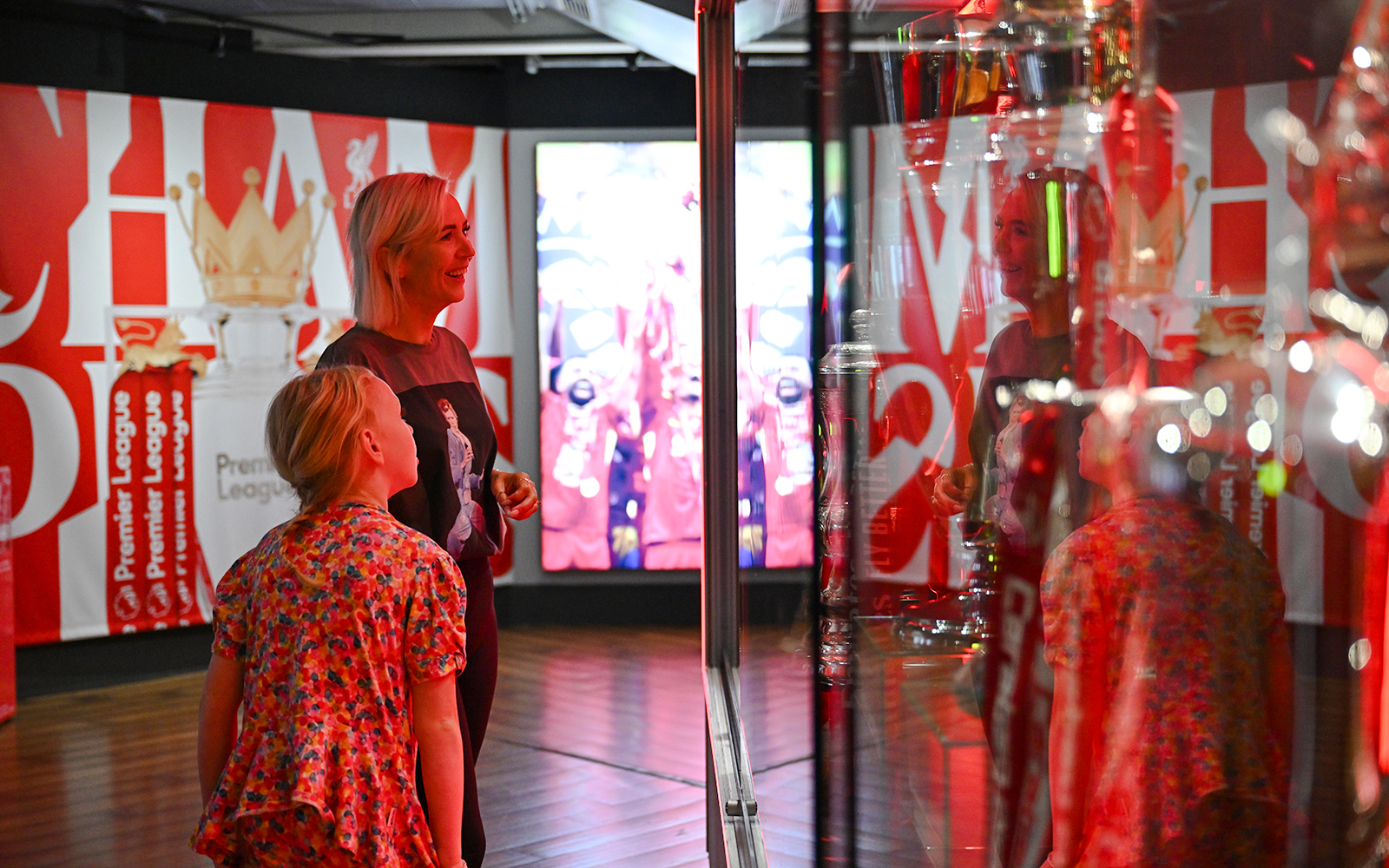 Visitors admiring trophies at Liverpool FC Museum, Anfield.