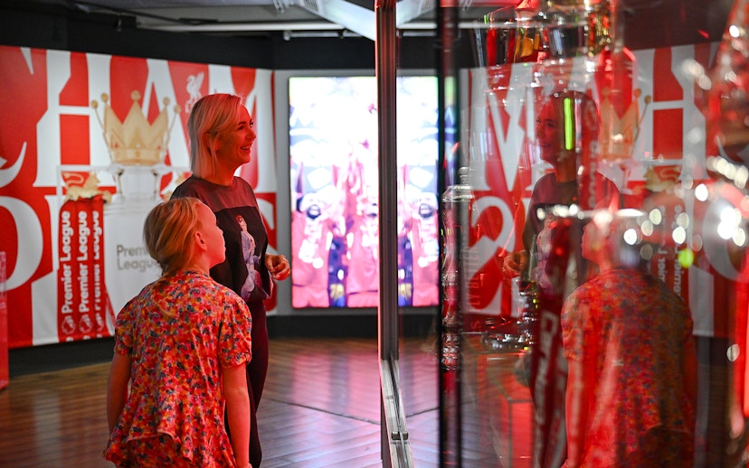 Visitors admiring trophies at Liverpool FC Museum, Anfield.