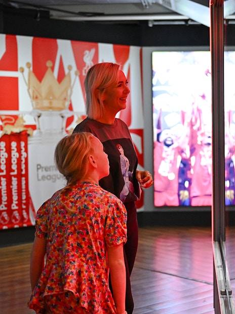 Visitors admiring trophies at Liverpool FC Museum, Anfield.