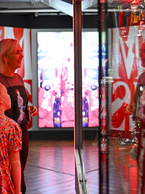 Visitors admiring trophies at Liverpool FC Museum, Anfield.