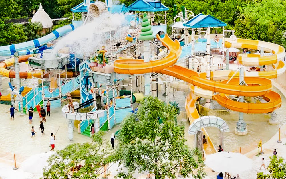 Visitors enjoying water slides at Ancol Atlantis Water Adventure Park, Jakarta.