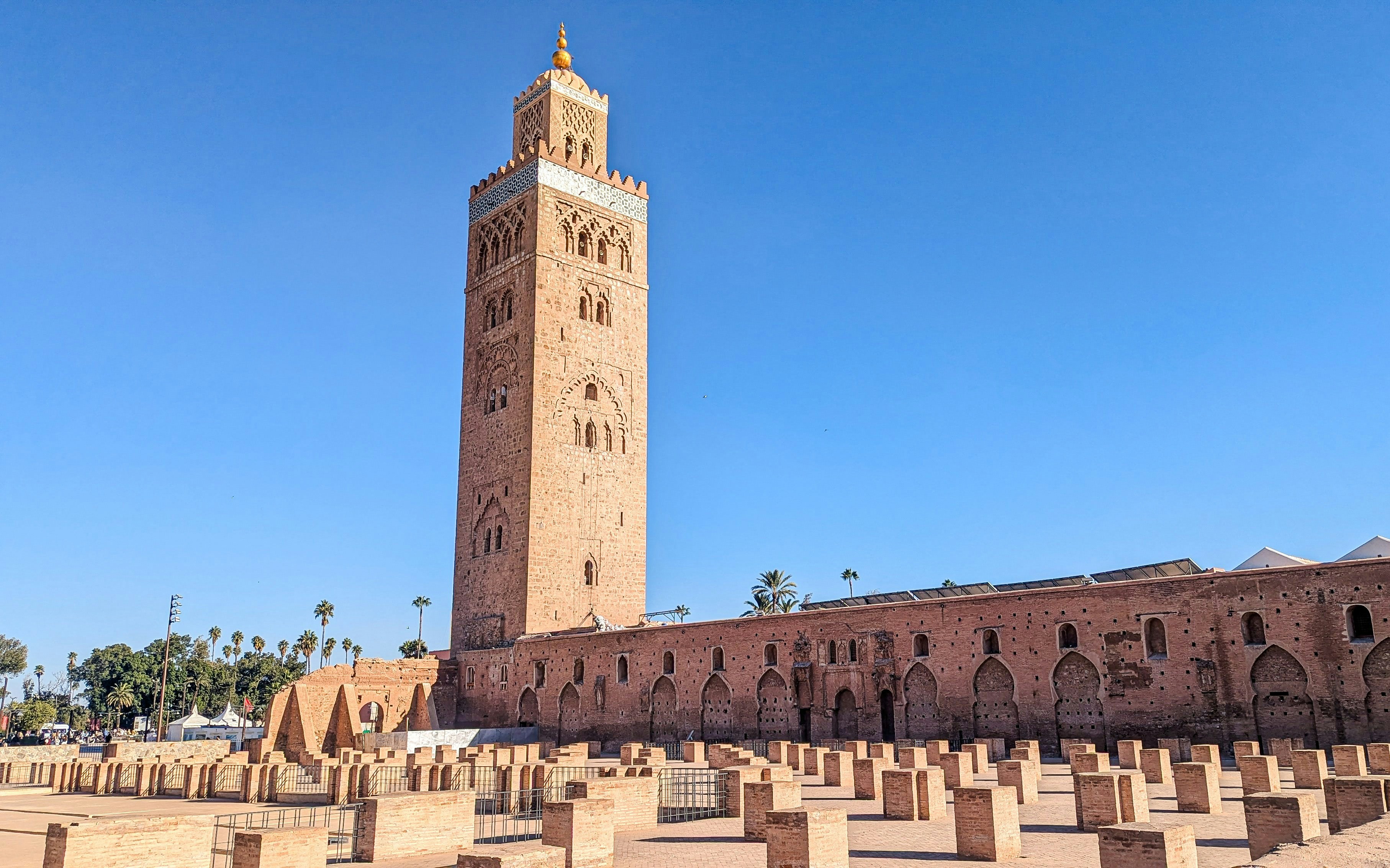Koutoubia Mosque with its minaret in Marrakech, Morocco, surrounded by stone columns.