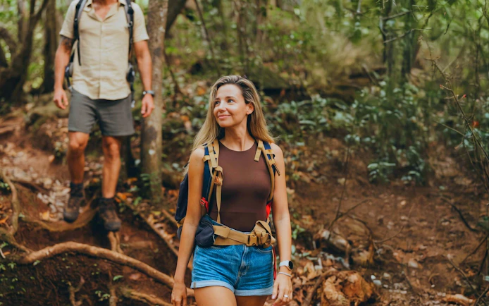 Hikers exploring forest trail on Bel Ombre wilderness tour.
