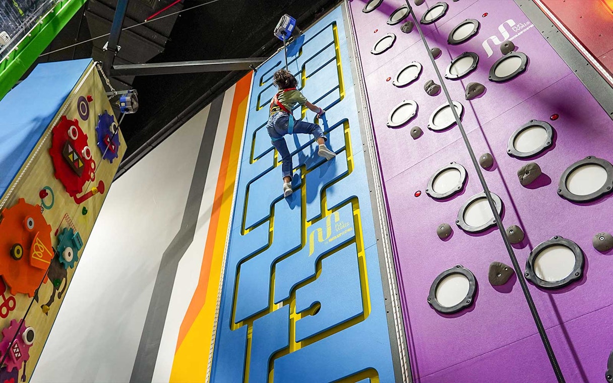 Child climbing interactive wall at Al Qana, Abu Dhabi.