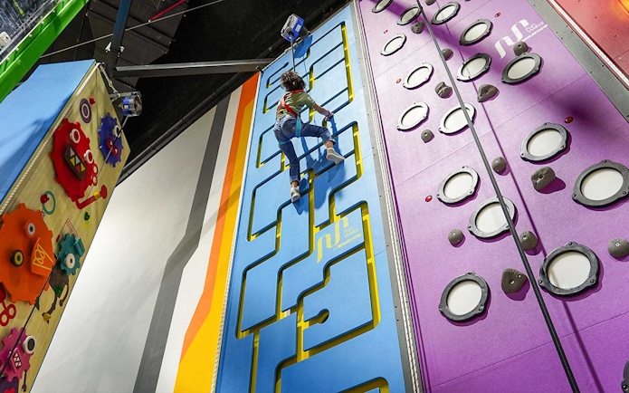 Child climbing interactive wall at Al Qana, Abu Dhabi.