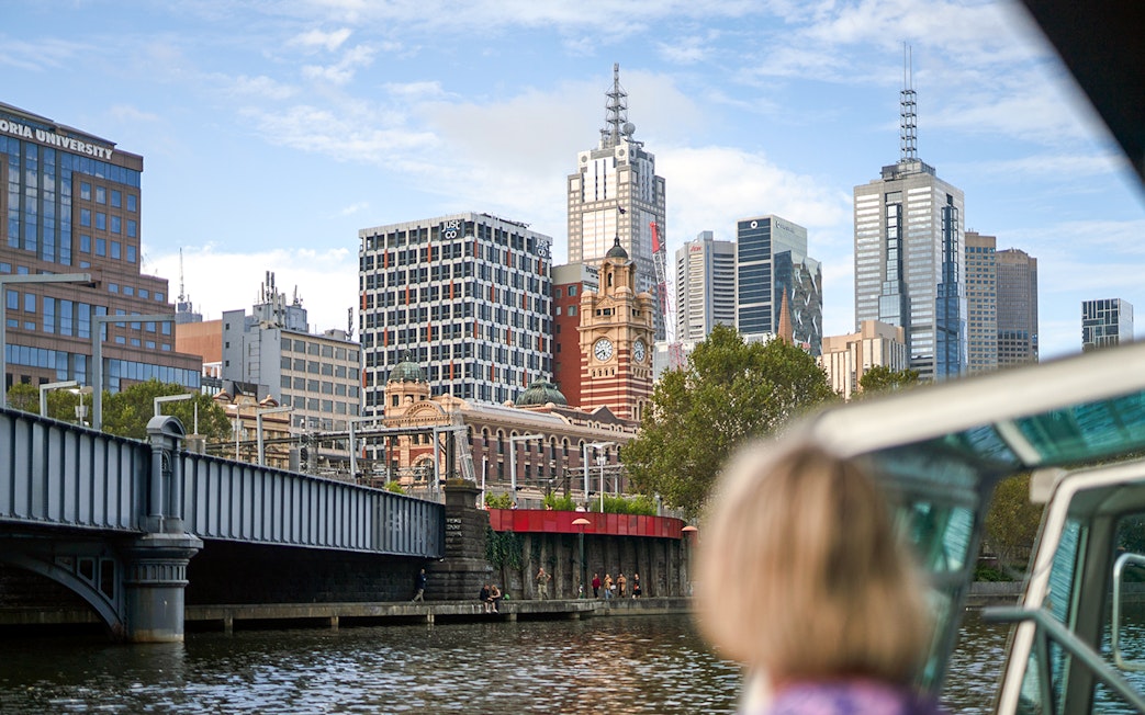 Guest viewing Melbourne skyline from a river cruise.