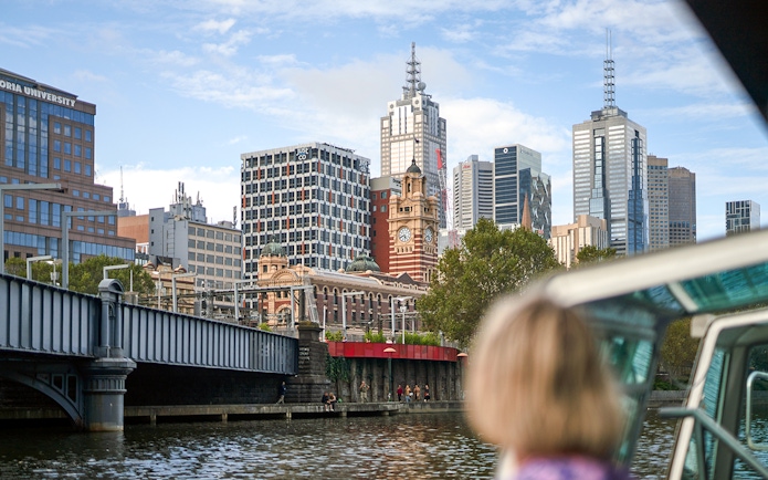 Guest viewing Melbourne skyline from a river cruise.