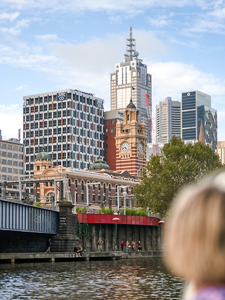 Guest viewing Melbourne skyline from a river cruise.
