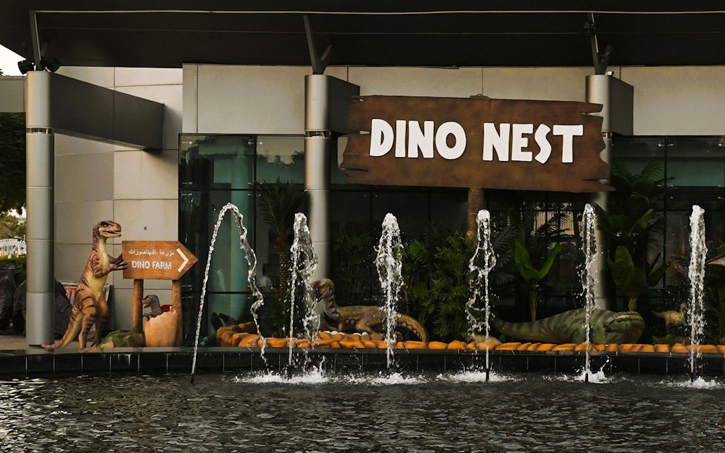 Dinosaur sculptures and fountains at Dino Nest, Dubai Garden Glow.