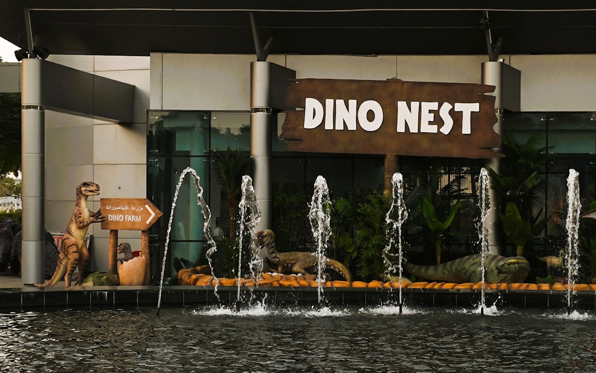 Dinosaur sculptures and fountains at Dino Nest, Dubai Garden Glow.