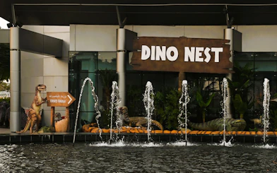 Dinosaur sculptures and fountains at Dino Nest, Dubai Garden Glow.