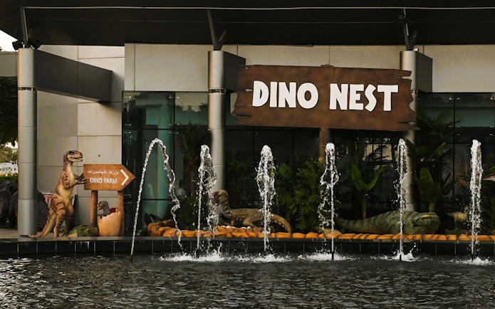 Dinosaur sculptures and fountains at Dino Nest, Dubai Garden Glow.
