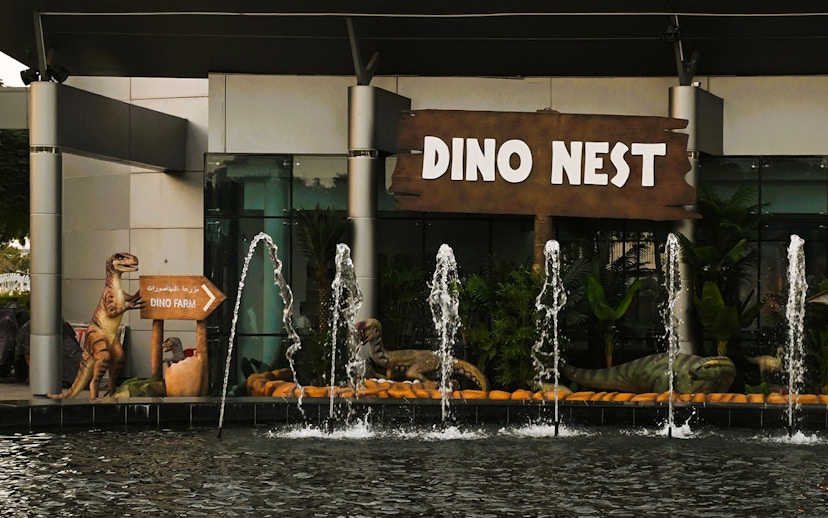 Dinosaur sculptures and fountains at Dino Nest, Dubai Garden Glow.