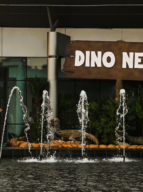 Dinosaur sculptures and fountains at Dino Nest, Dubai Garden Glow.