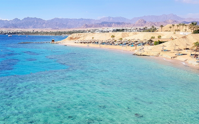 Magic Lake shoreline at Ras Muhammad National Park, Egypt, with clear blue waters and sandy beach.