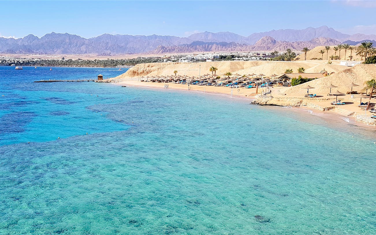 Magic Lake shoreline at Ras Muhammad National Park, Egypt, with clear blue waters and sandy beach.