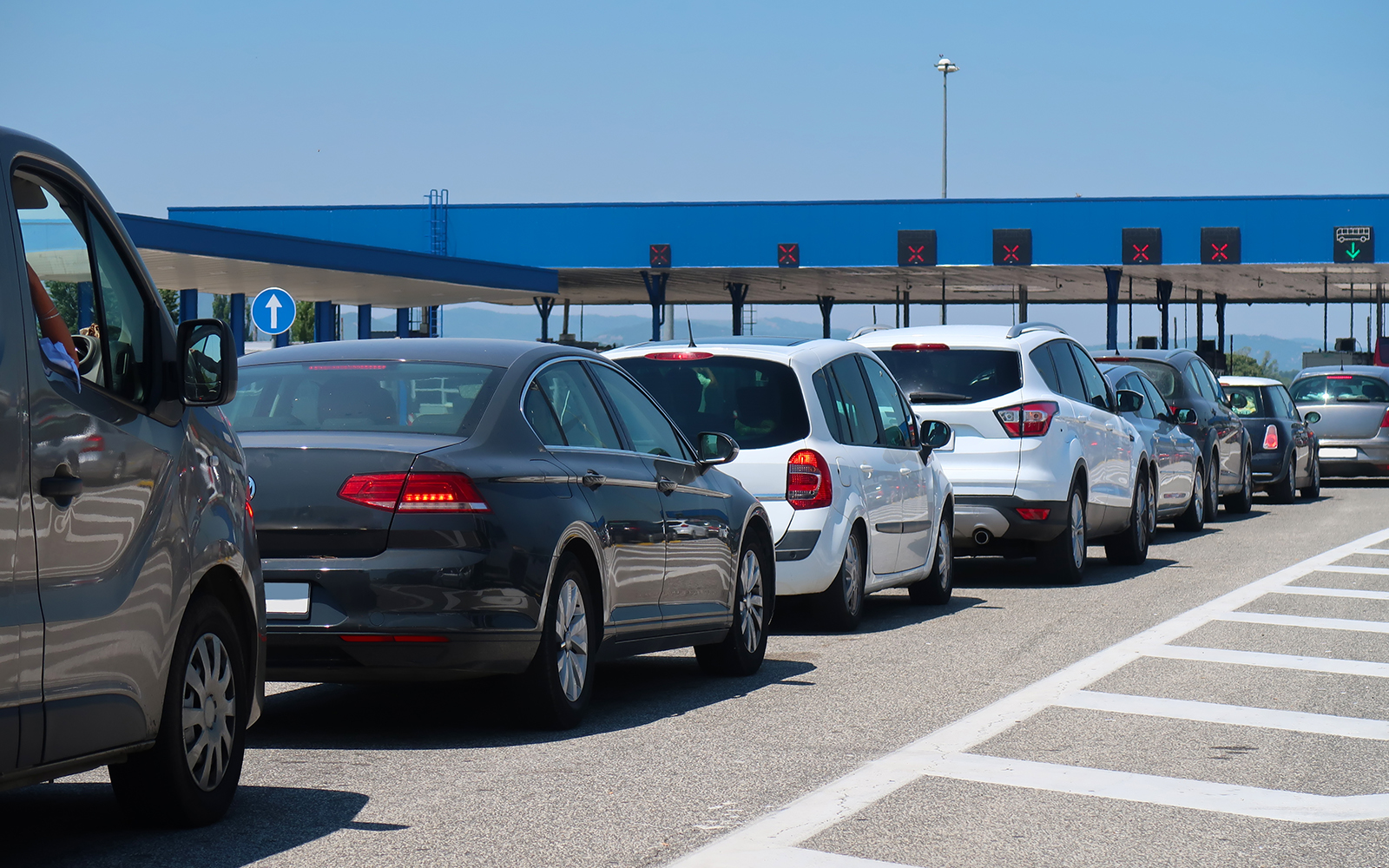 Border check post with travelers and vehicles in line, enhancing border crossing experience.