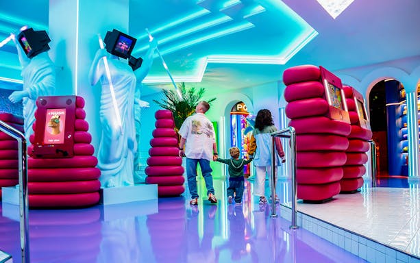 Dubai Aquarium & Underwater Zoo entrance with visitors exploring Penguin Cove exhibit.