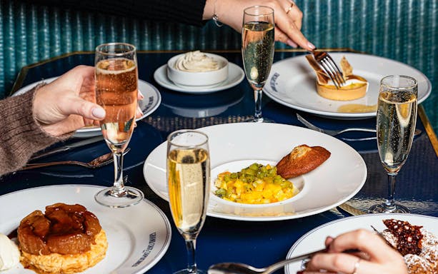 Diners enjoying apéritif and desserts at Opéra-Grand Café Capucines, Paris.