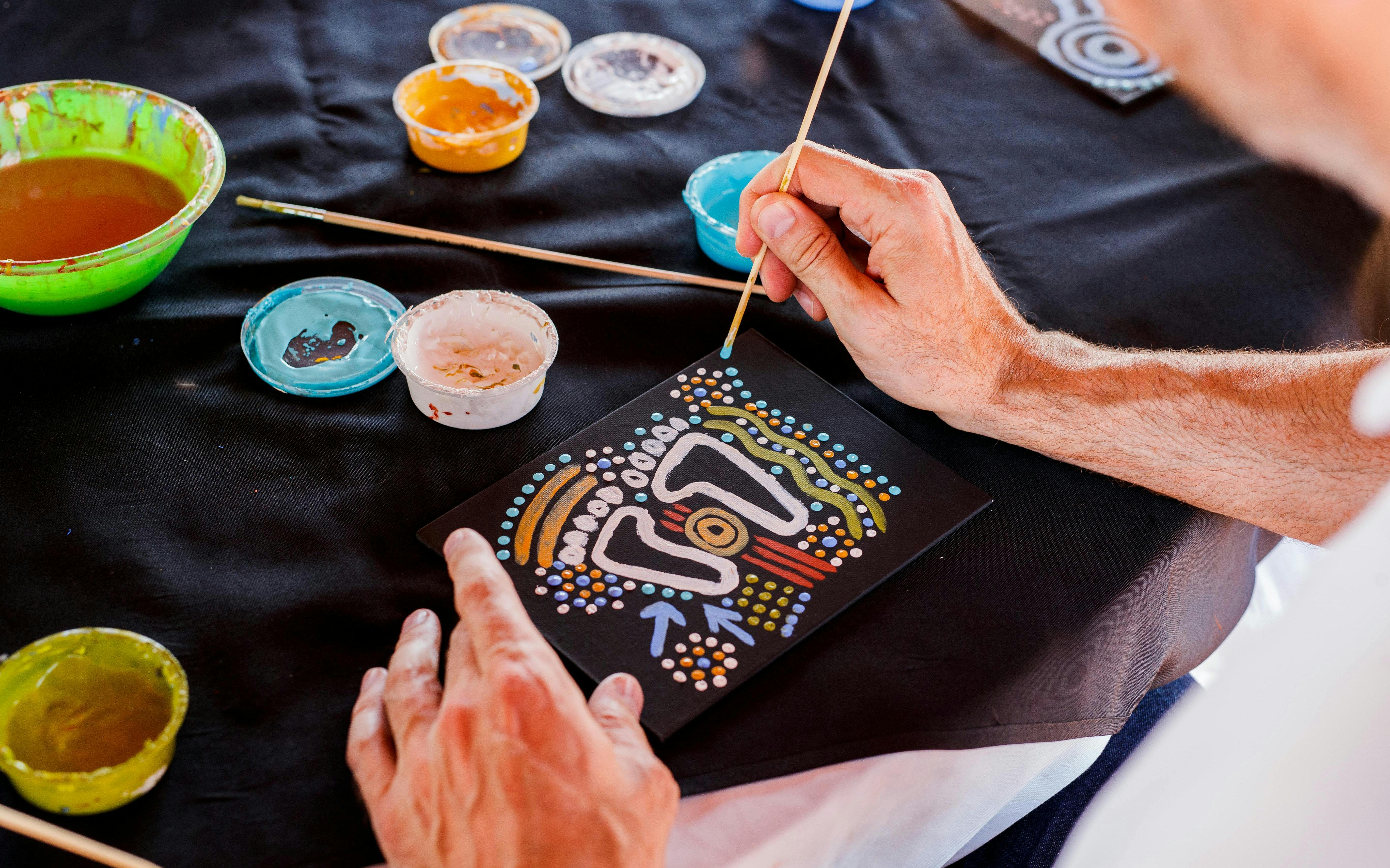 Aboriginal dot painting activity during Sunrise Uluru & Kata Tjuta Half Day Tour.