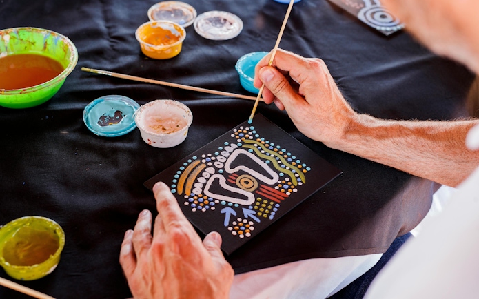 Aboriginal dot painting activity during Sunrise Uluru & Kata Tjuta Half Day Tour.