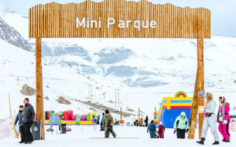 Farellones Park entrance with visitors and snow activities, Santiago.