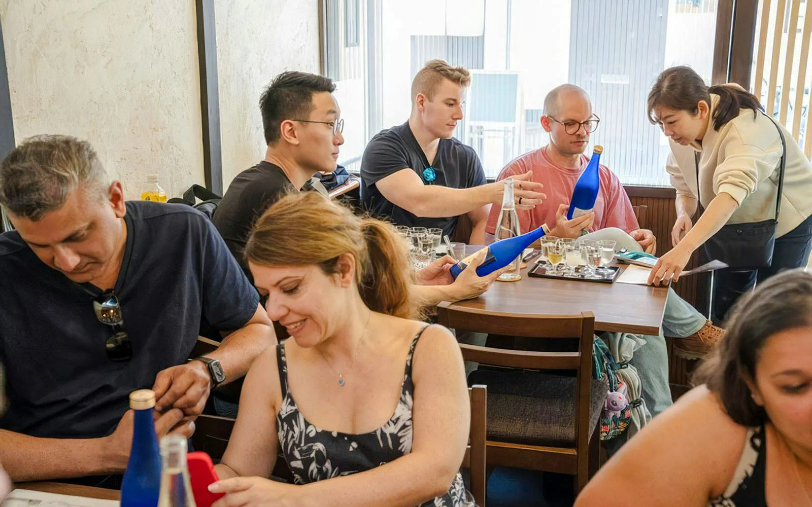 Tourists tasting sake at Kyoto Insider Sake Experience.