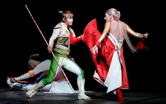 Performers in dynamic action scene from Cirque du Soleil KÀ show.