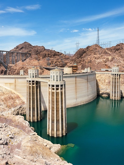 Hoover Dam with turquoise Lake Mead and surrounding rocky landscape near Las Vegas, Nevada.