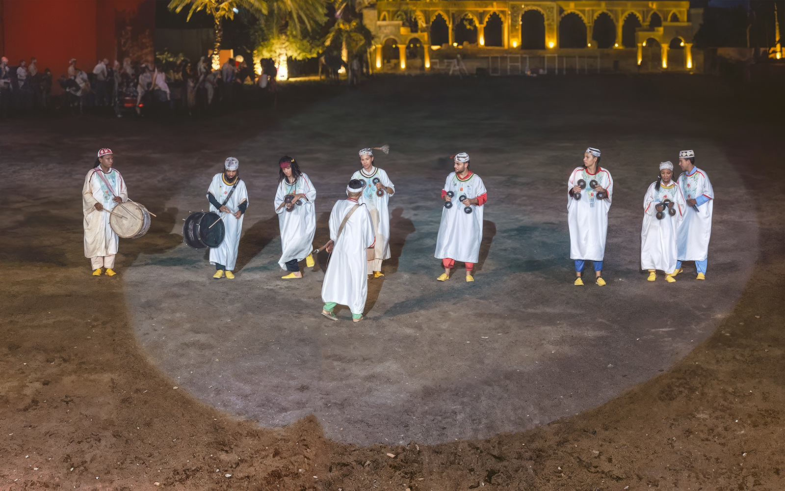 Performers in traditional attire playing instruments at Chez Ali Dinner & Fantasia Show, Morocco.