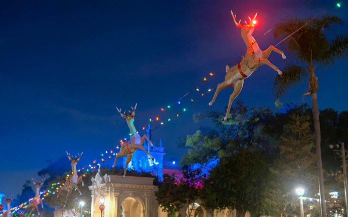 Reindeer decorations with colorful lights at night on Old Town Trolley's Holiday Sights Tour, San Diego.