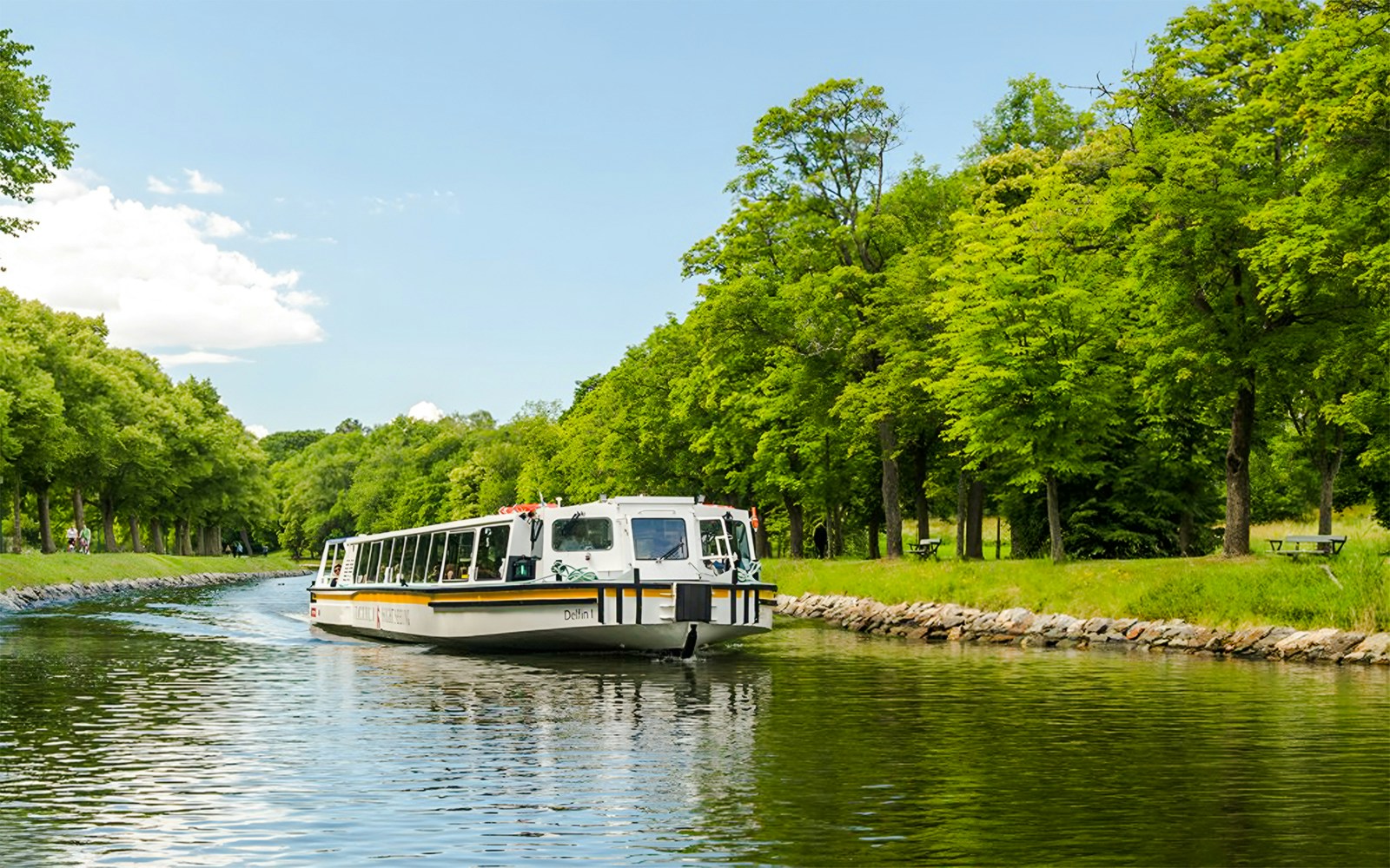 Djurgården City Canal Cruise boat navigating through Stockholm's scenic waterways.