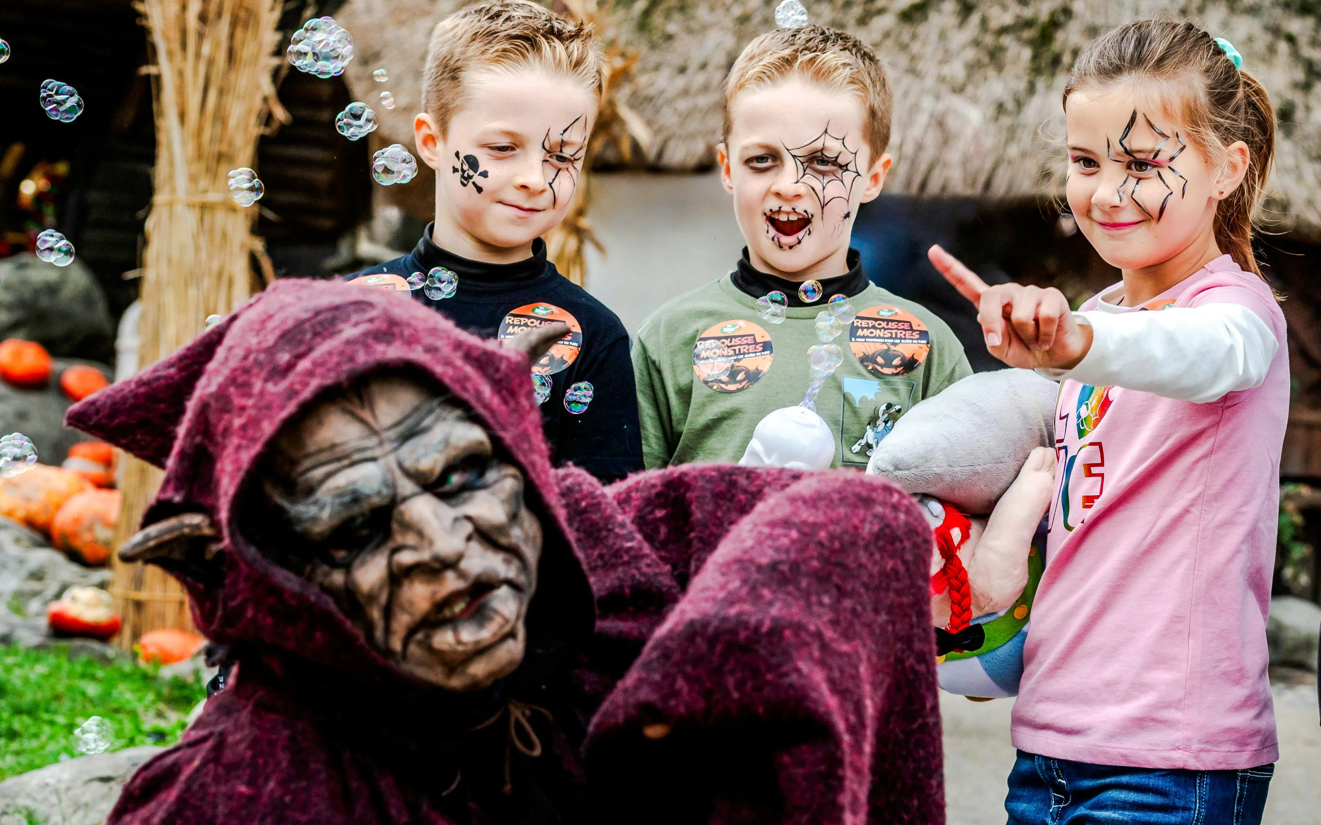 Children with face paint enjoying Halloween at Parc Asterix, Paris, France.