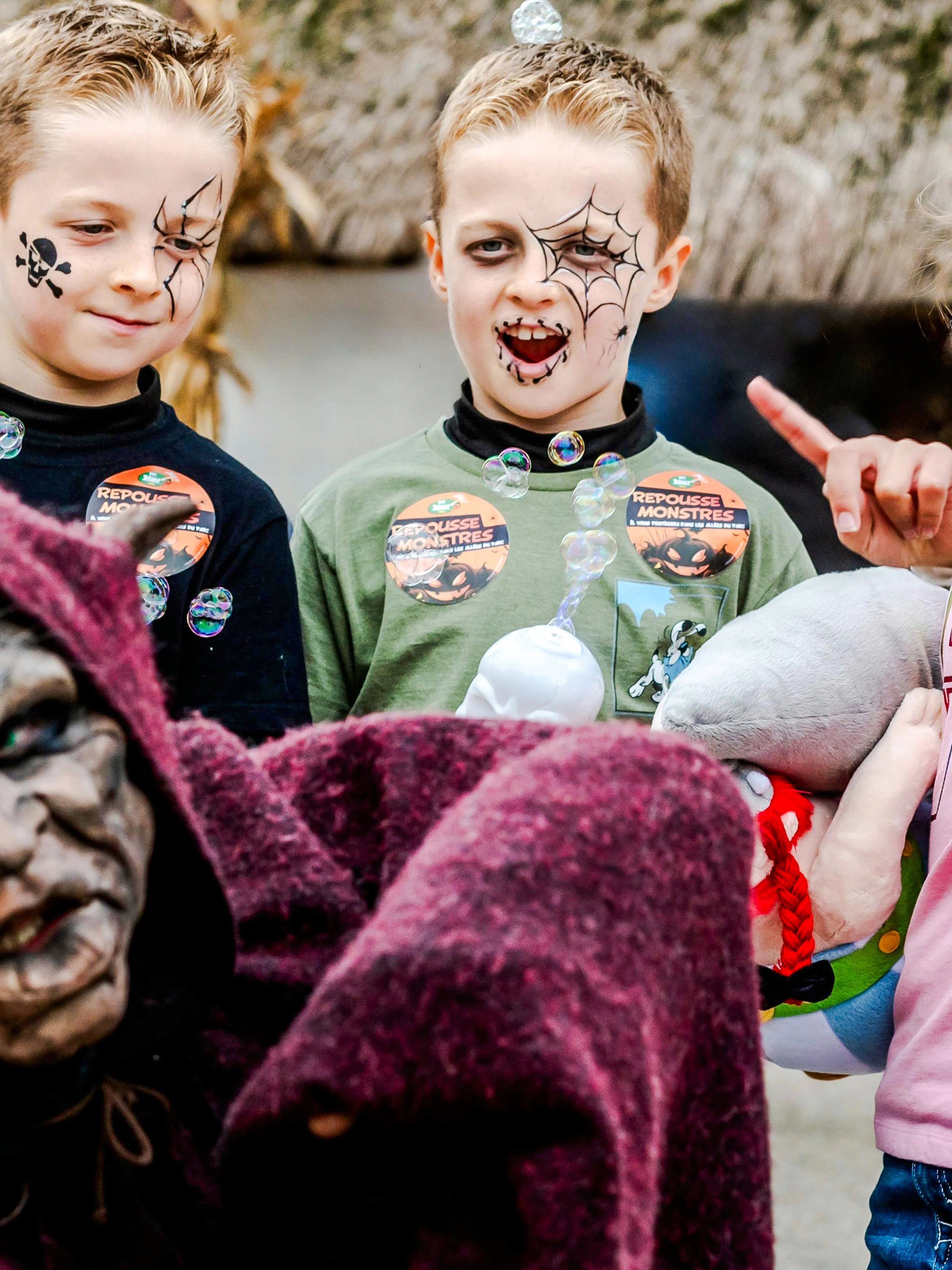 Children with face paint enjoying Halloween at Parc Asterix, Paris, France.