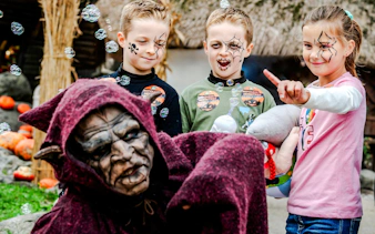 Children with face paint enjoying Halloween at Parc Asterix, Paris, France.