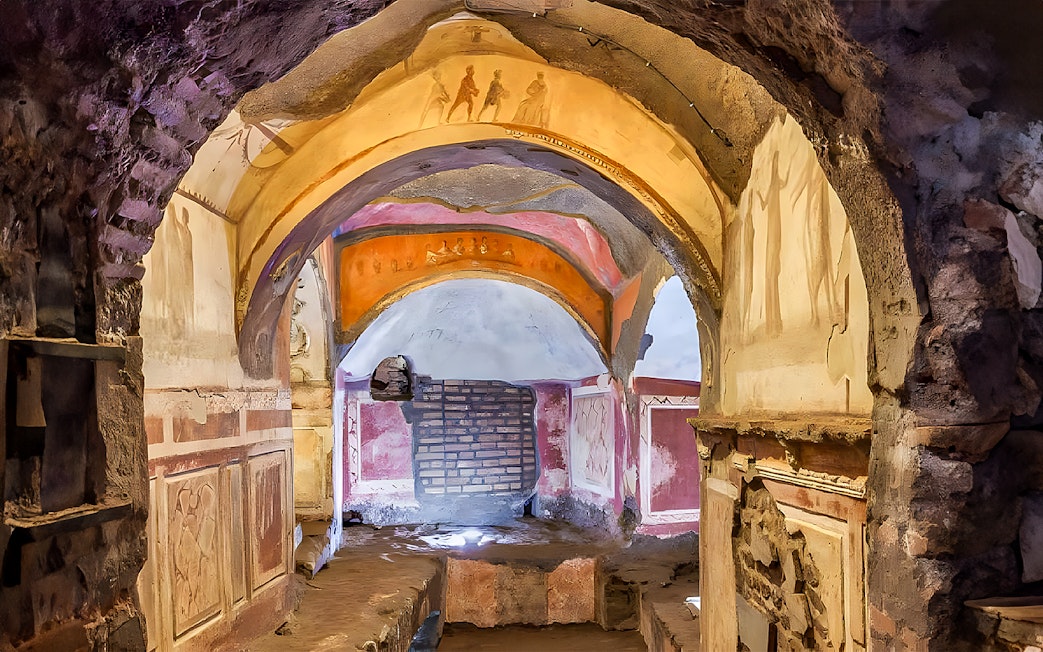 Catacombs passage with frescoes, Rome guided tour.