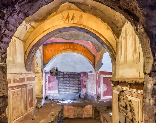 Group of tourists exploring the Roman Catacombs and Capuchin Crypts on a guided tour from Rome, standing in front of the Basilica of San Nicola