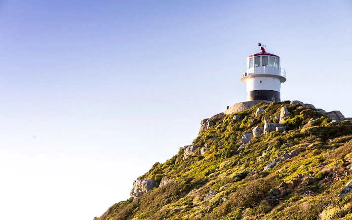 Lighthouse on rocky hill at Cape of Good Hope, Cape Town.