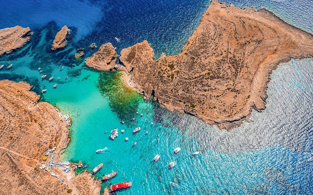 Aerial view of boats near Comino's Blue Lagoon, Malta, on a Turkish Gulet cruise from Sliema.