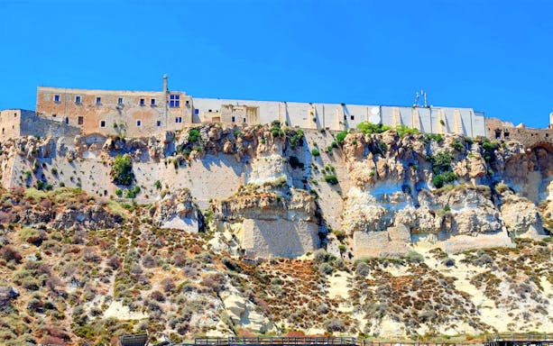 Historic fortress on rocky cliffs of Tremiti Islands, Italy, viewed from ferry ride.