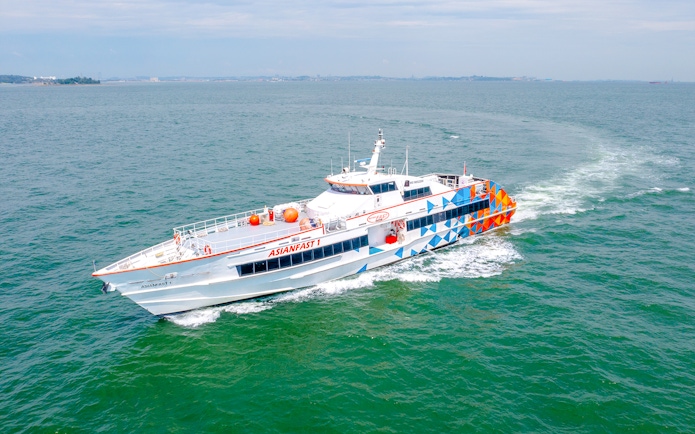 Ferry traveling from Singapore to Batam across the sea.
