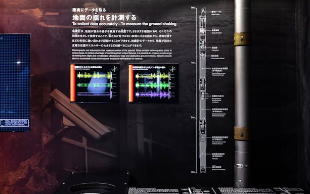 Seismograph display at Miraikan's Permanent Exhibition showing earthquake data analysis.